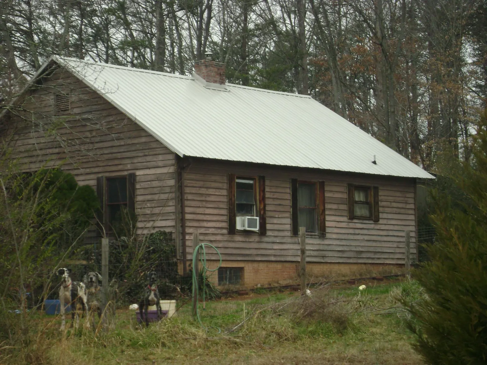 White metal roof on an old wood sided farmhouse, from a Metal Roof Installation job in Englishtown